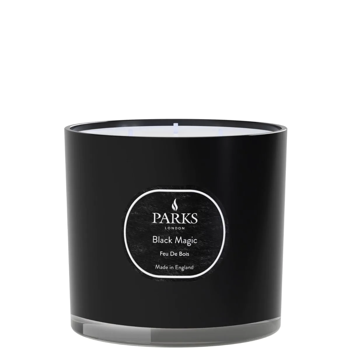 A black candle jar with a label reading 'PARKS Black Magic Feu De Bois', indicating a warm and woody fragrance.