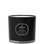 A black candle with a white label that reads 'PARKS', 'Black Magic', 'Sandalwood & Ylang Ylang', and 'Made in England'.