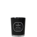 A black candle with a white label that reads 'PARKS Black Magic Sandalwood & Ylang Ylang'. The candle is unlit and has a clean, minimalist design.