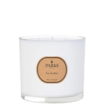 A white, glass-enclosed three-wick candle with a 'PARKS Feu De Bois' label on the front.