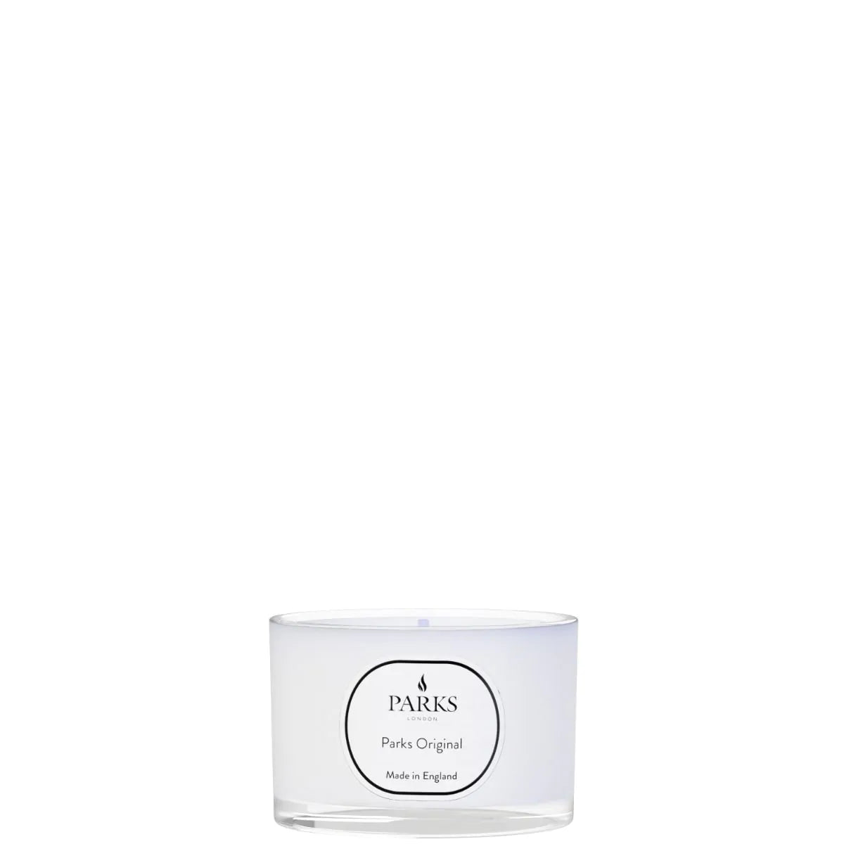 A Parks Original travel candle in a clear glass vessel with a white label, featuring the brand's logo.