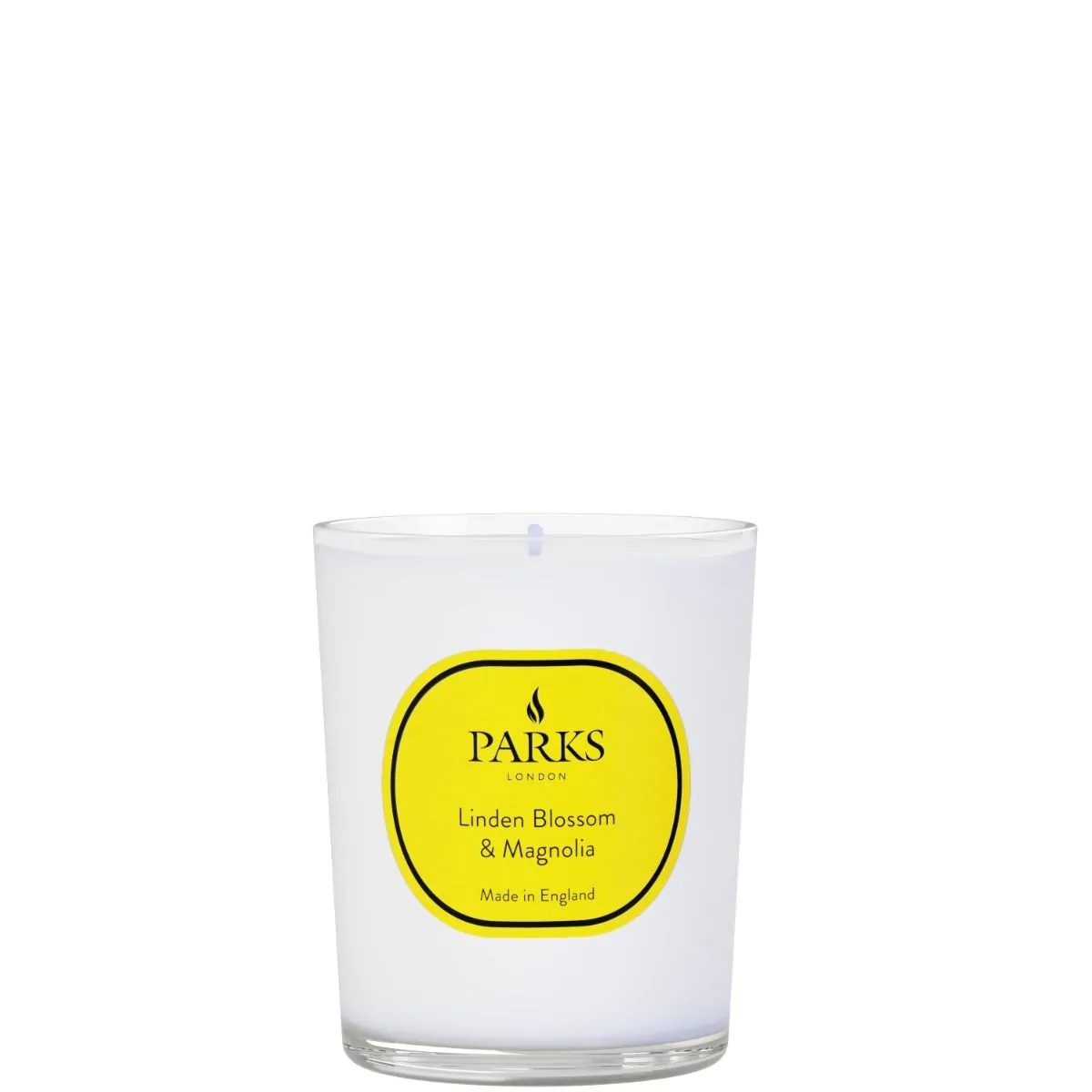A white candle with a yellow label that reads 'PARKS Linden Blossom & Magnolia', indicating the fragrance of the candle.