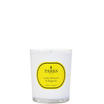 A white candle with a yellow label that reads 'PARKS Linden Blossom & Magnolia', indicating the fragrance of the candle.