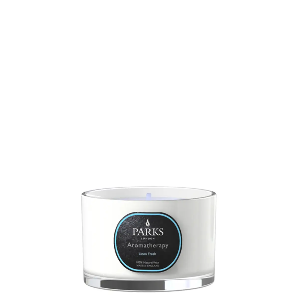 A white travel-sized candle with a label that reads 'PARKS Aromatherapy Linen Fresh' in a clear glass vessel with a silver base.