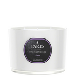 A white, glass vessel candle with the label 'PARKS Aromatherapy Cassis'. The candle is part of the Aromatherapy collection and appears to be made from natural wax.