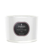 A white, glass vessel candle with the label 'PARKS Aromatherapy Rose' on the front.