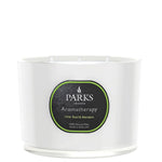 A white, 3-wick candle with a label that reads 'PARKS Aromatherapy, Lime, Basil & Mandarin', indicating the fragrance.