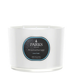 A white, 3-wick candle with a label that reads 'PARKS Aromatherapy Linen Fresh', indicating it is a scented candle with natural wax.