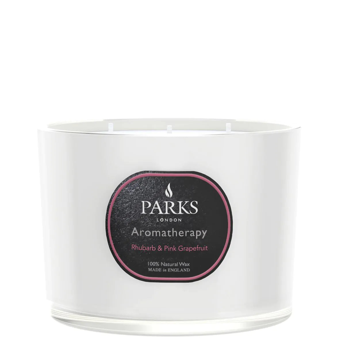A white, glass vessel candle with a label that reads 'PARKS Aromatherapy Rhubarb & Pink Grapefruit'. The candle is unlit and appears to be a luxury product.