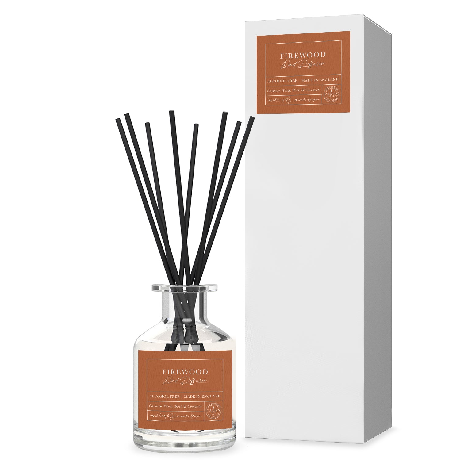 A clear glass diffuser bottle with black reeds and a label reading 'Firewood', alongside a white box with 'Firewood' and the seasons 'Autumn' & 'Winter' indicated on it.
