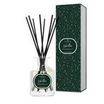 Diffuser bottle with black reeds and decorative box on a white background