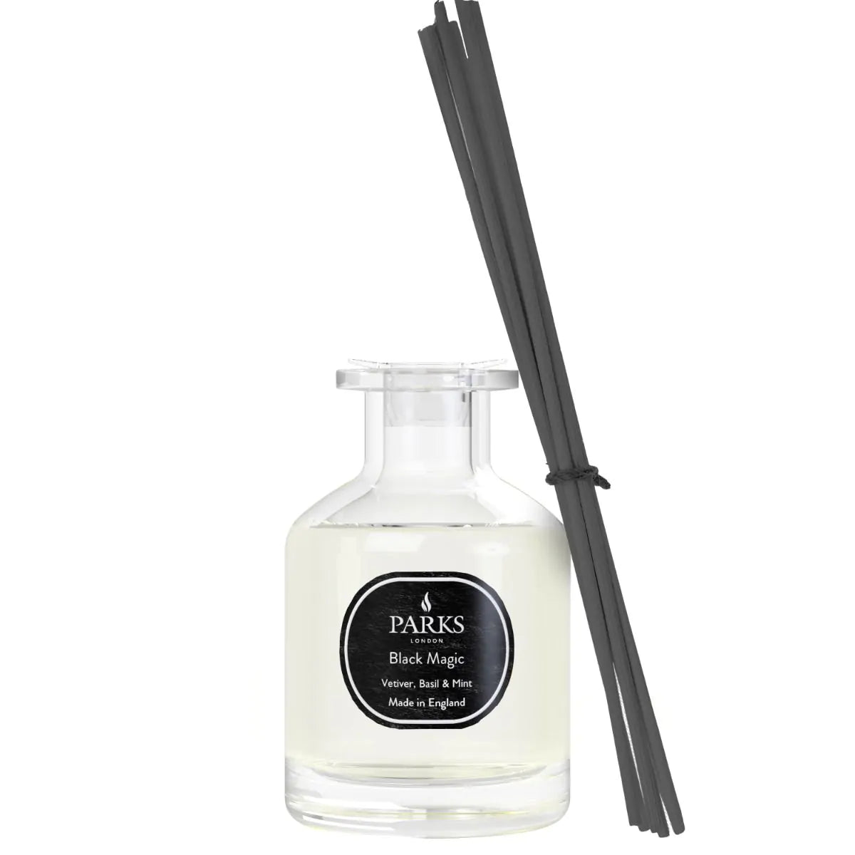A clear glass diffuser bottle with black reeds, labeled 'PARKS Black Magic', indicating the fragrance as Vetiver, Basil & Mint.